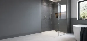 Finished modern wet room with grey tiles and chrome fittings
